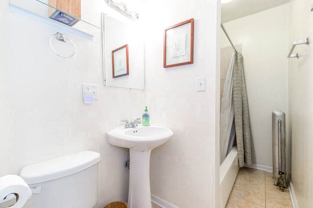 a bathroom with a sink and a toilet and a shower