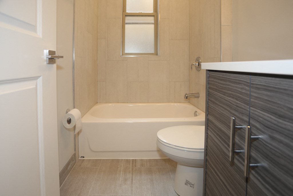 a small bathroom with a toilet and a bath tub