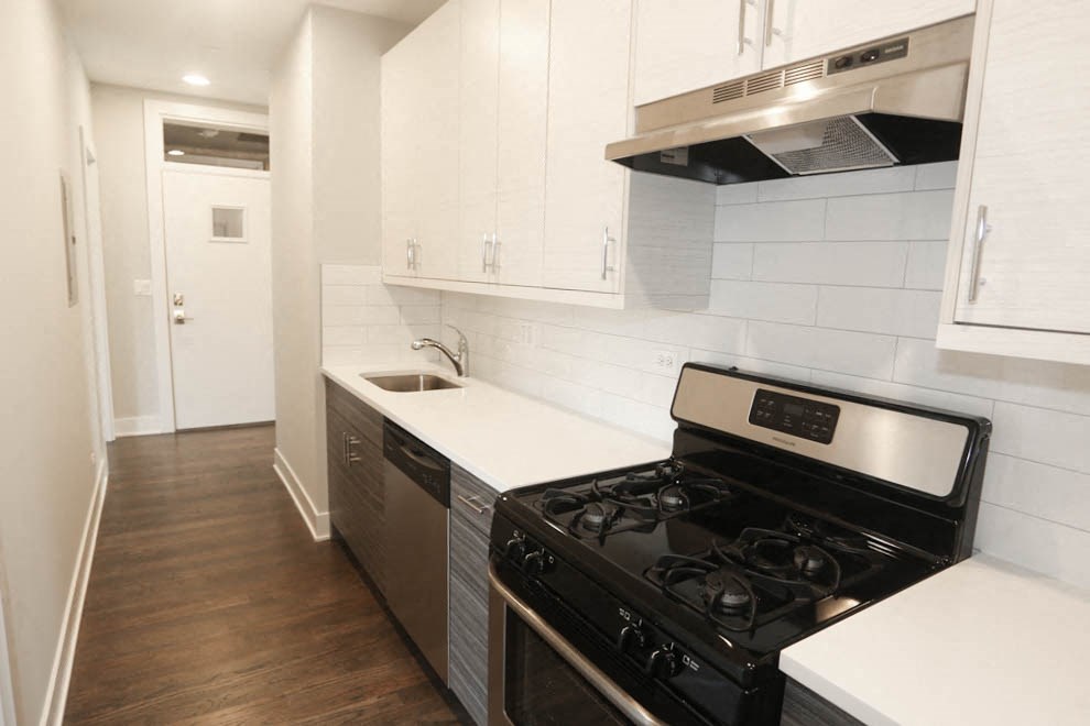 a kitchen with a stove and a sink