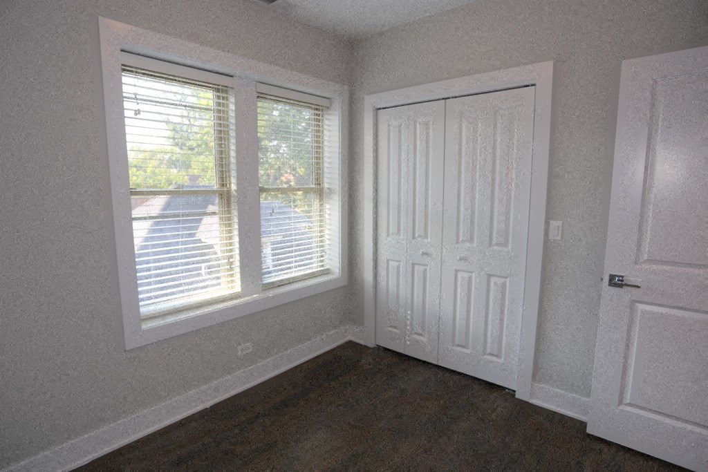 a small room with a window and a door