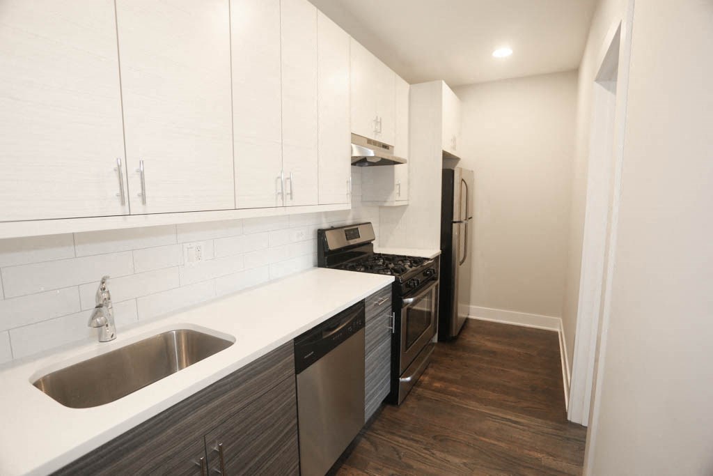 a kitchen with a sink and a refrigerator
