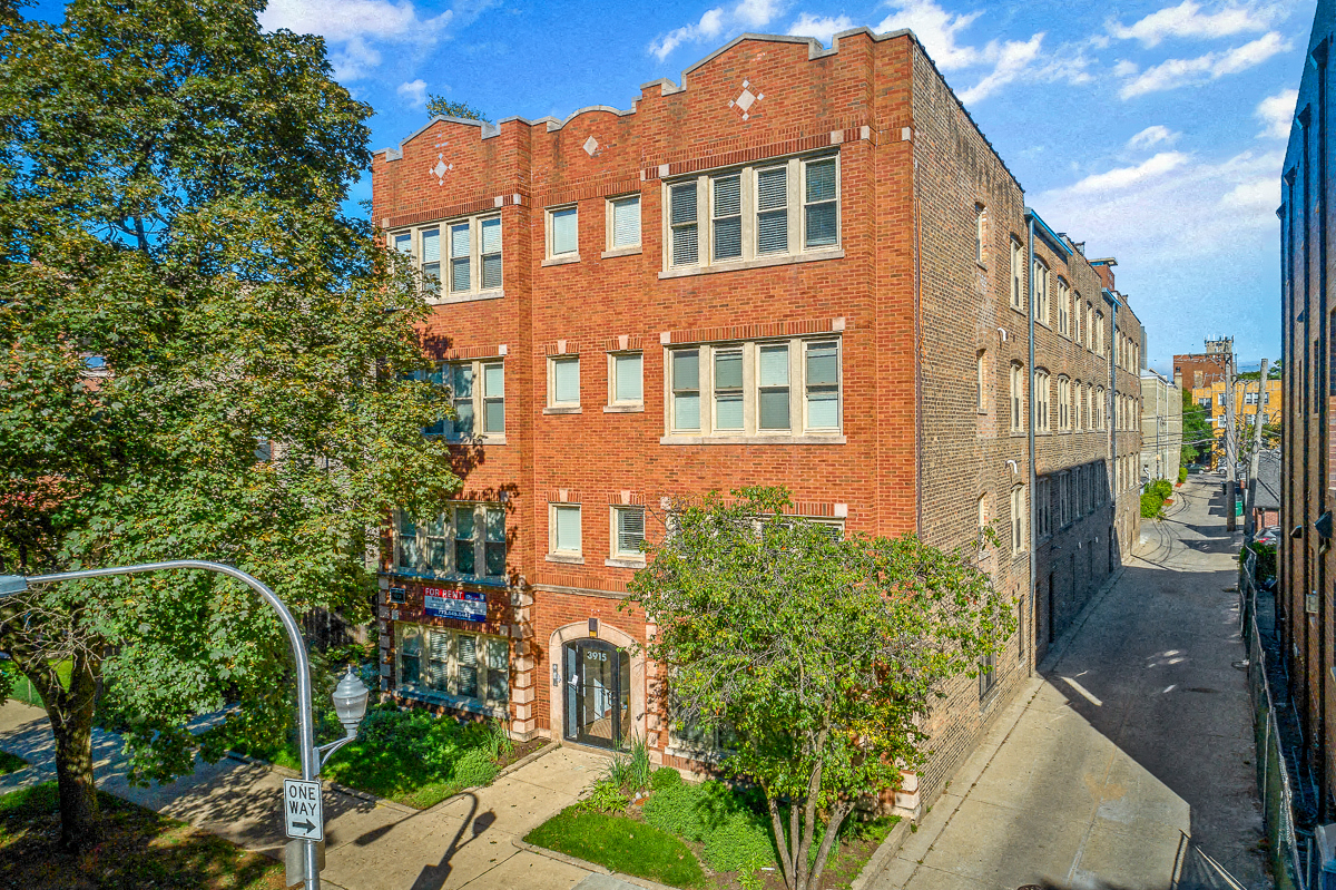a red brick building with a street in front of it