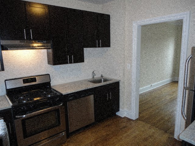 a kitchen with a stove and a sink