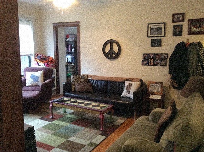 a living room with a checkered rug and couches