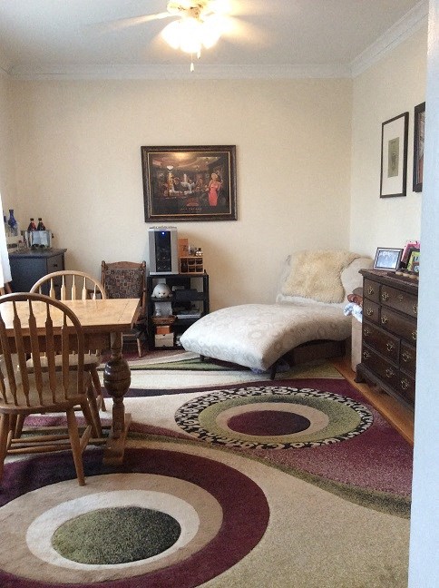 a living room with a table and a bed