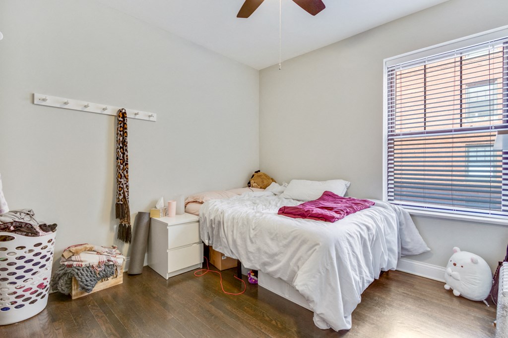 a bedroom with a bed and a ceiling fan