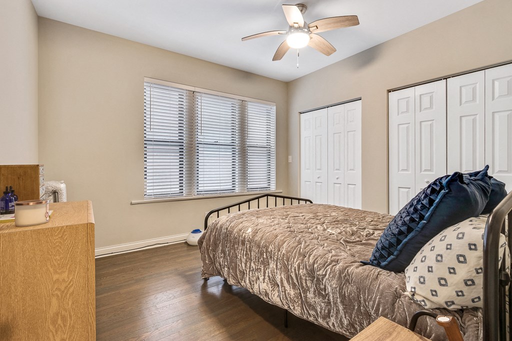 a bedroom with a bed and a ceiling fan