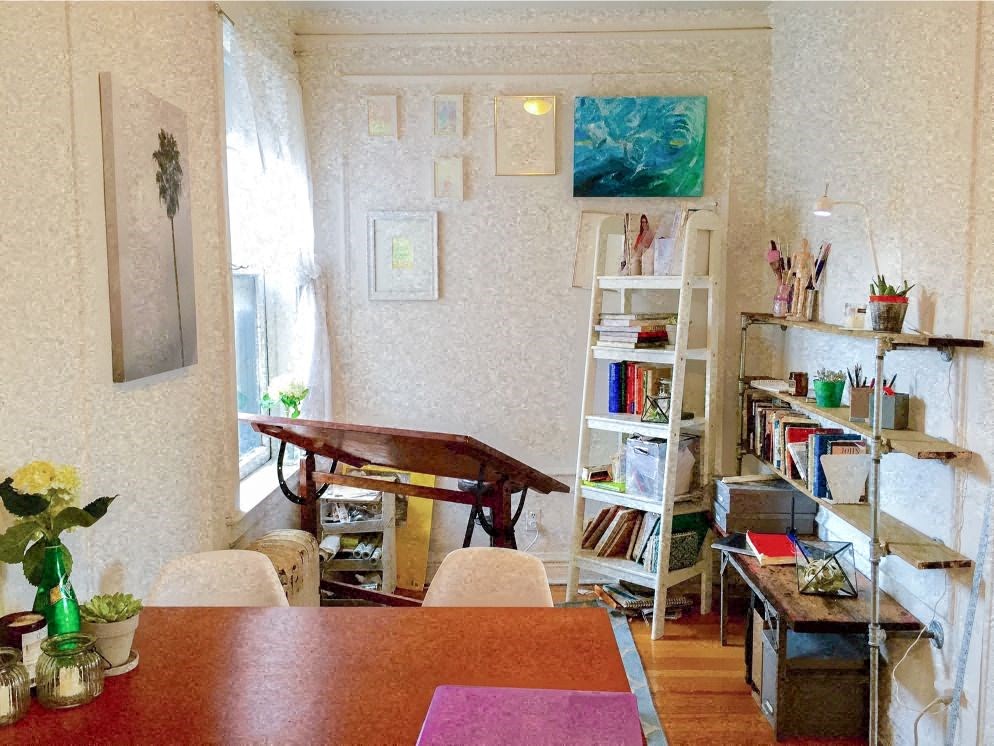 a dining room with a table and chairs and a bookshelf