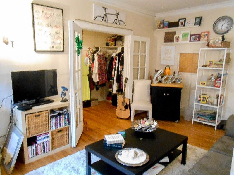 a living room with a television and a closet
