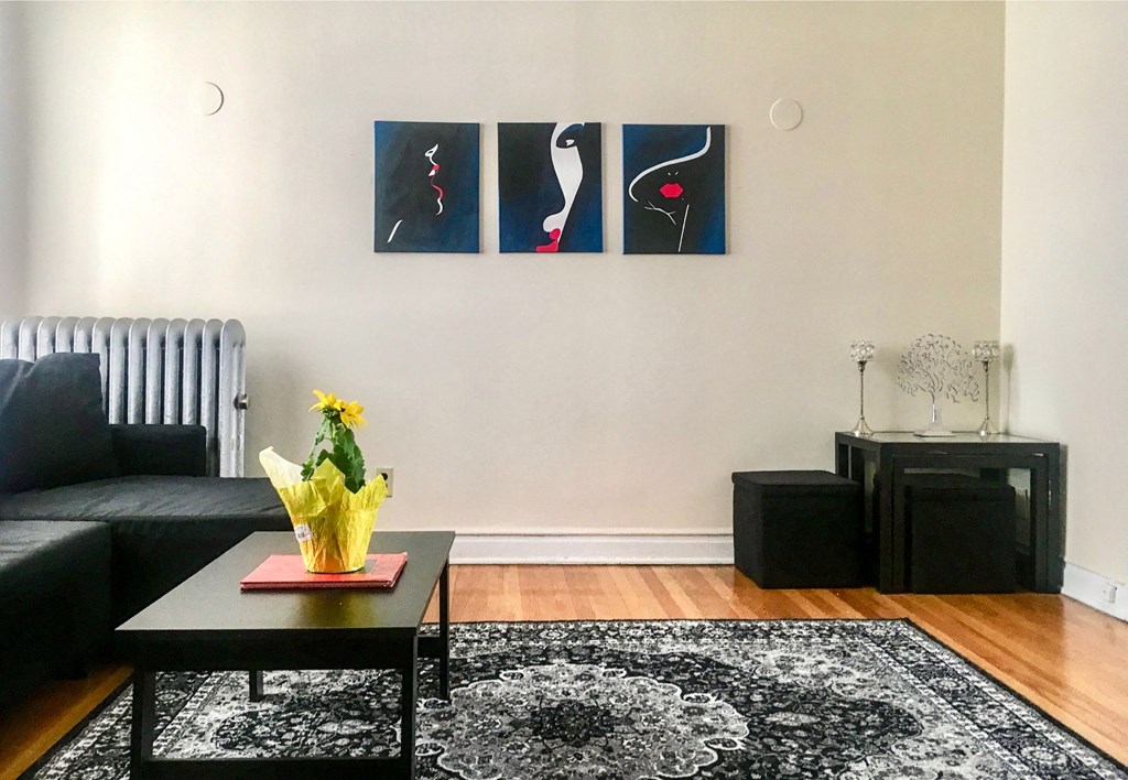 a living room with a black couch and a coffee table