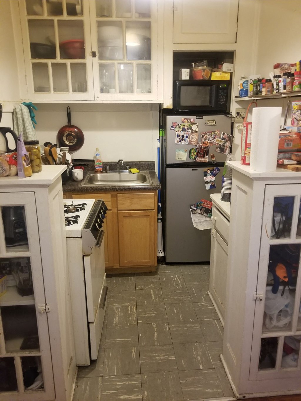 a small kitchen with a stove refrigerator and sink