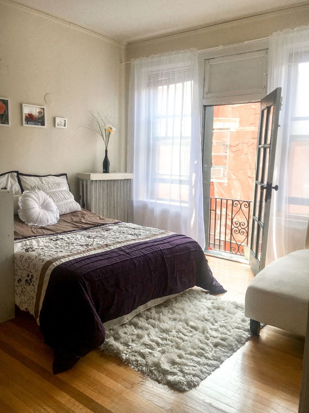 a bedroom with a bed and a door to a balcony