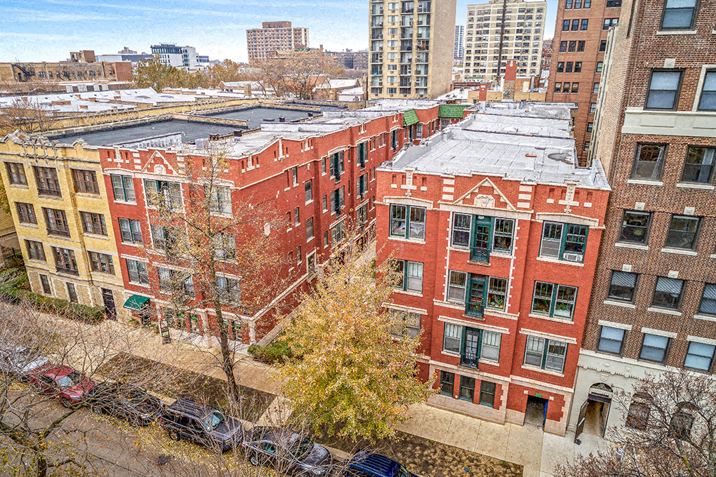 an aerial view of a row of buildings in the city