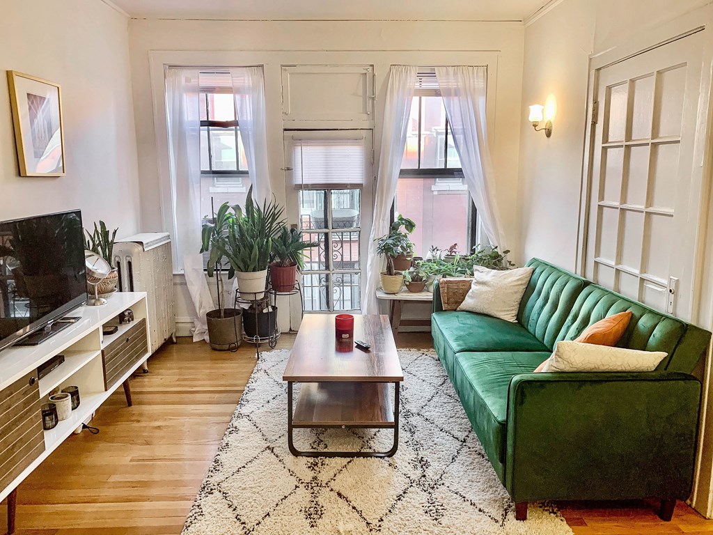 a living room with a green couch and a coffee table
