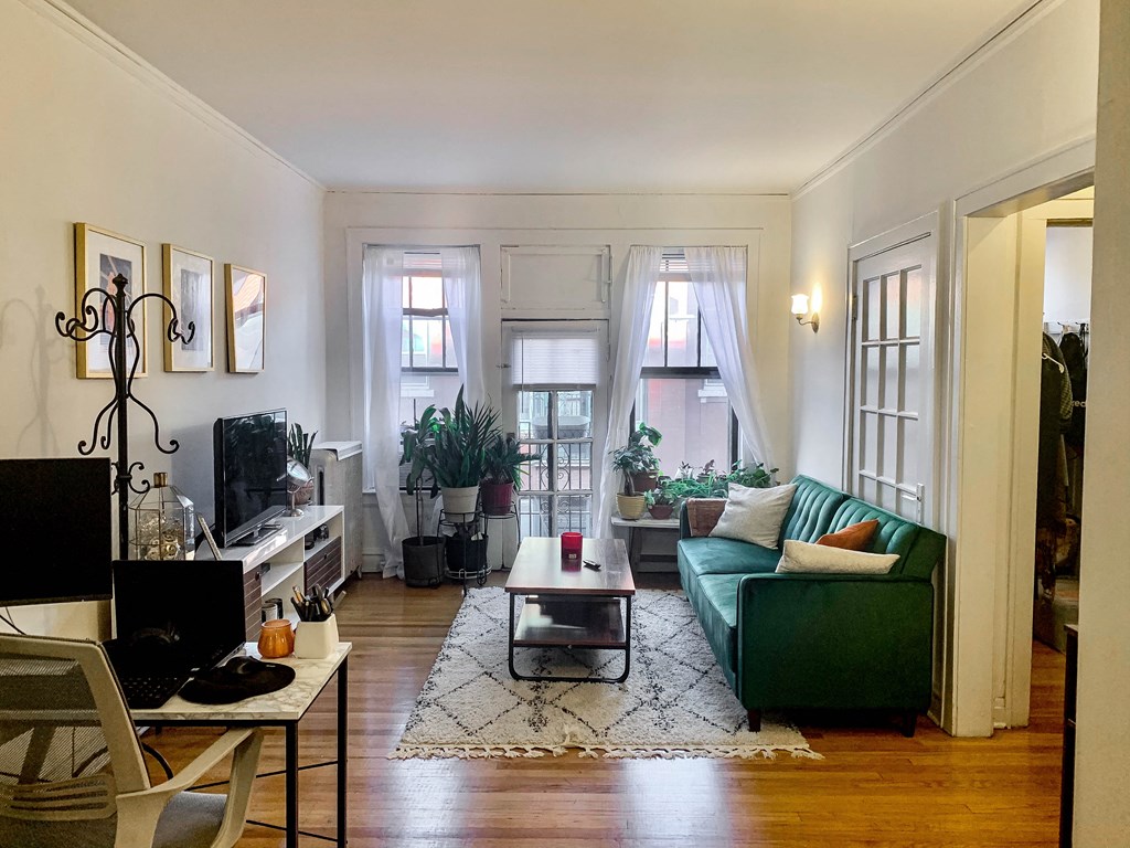 a living room with a green couch and a table
