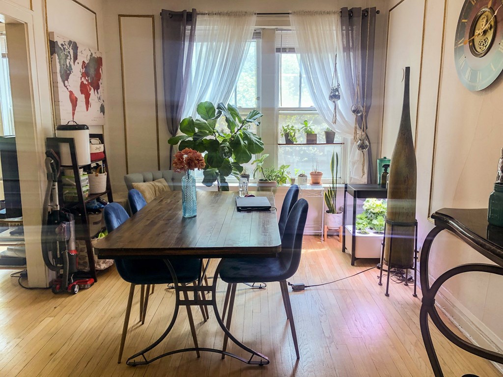 a dining room with a table and chairs and a window