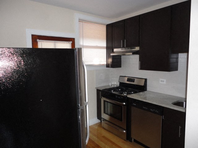 a kitchen with a stove and a refrigerator