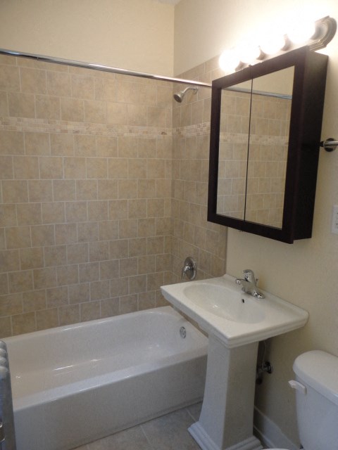 a bathroom with a sink and a tub and a mirror