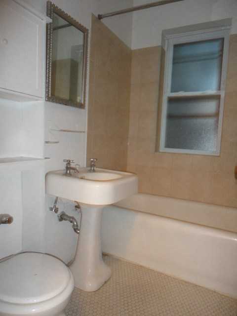 a white bathroom with a sink and a toilet