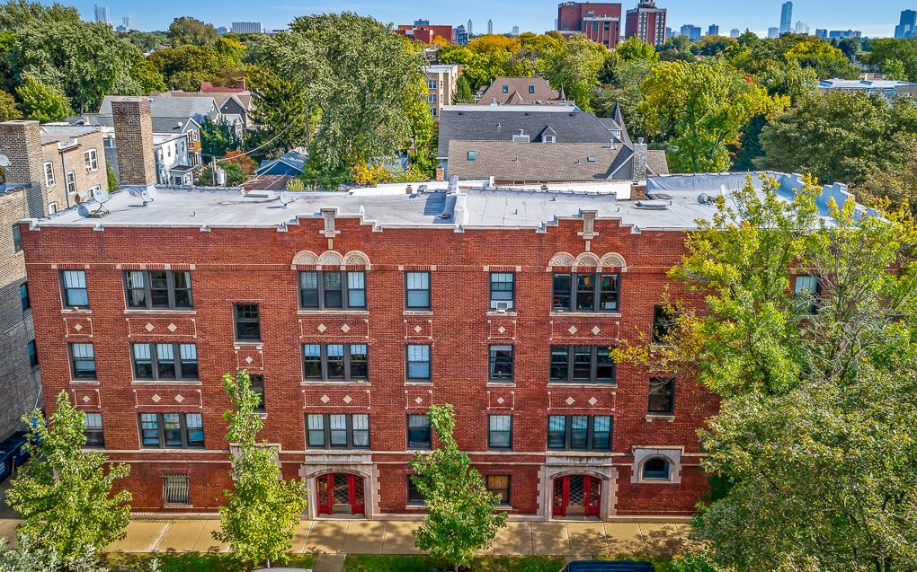 a large brick building with trees in front of it
