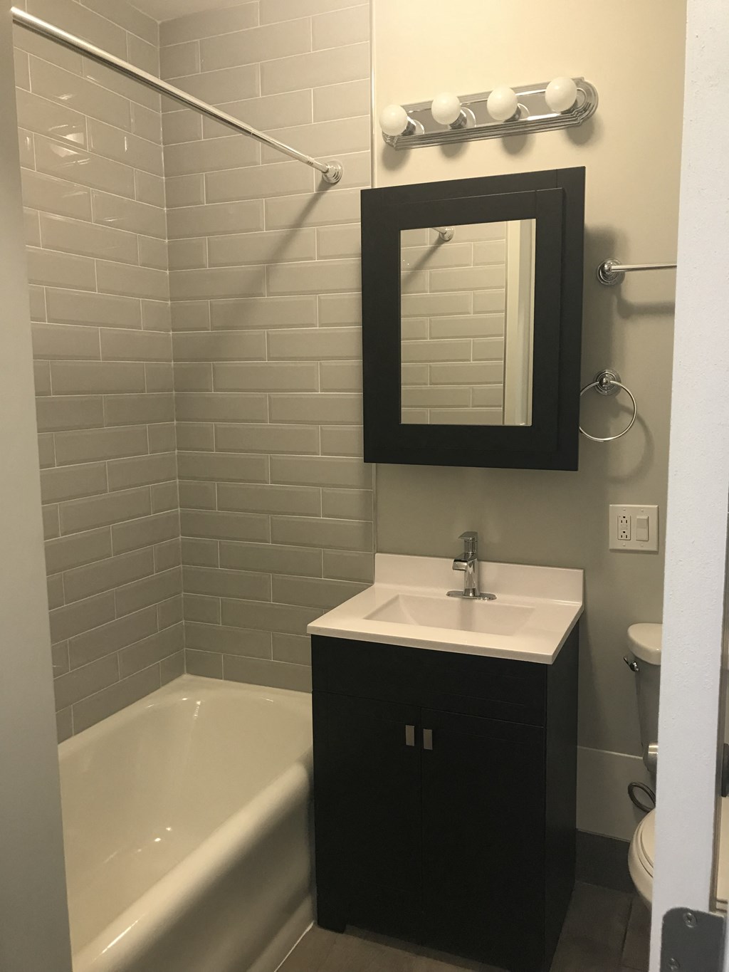 a small bathroom with a sink and a bath tub