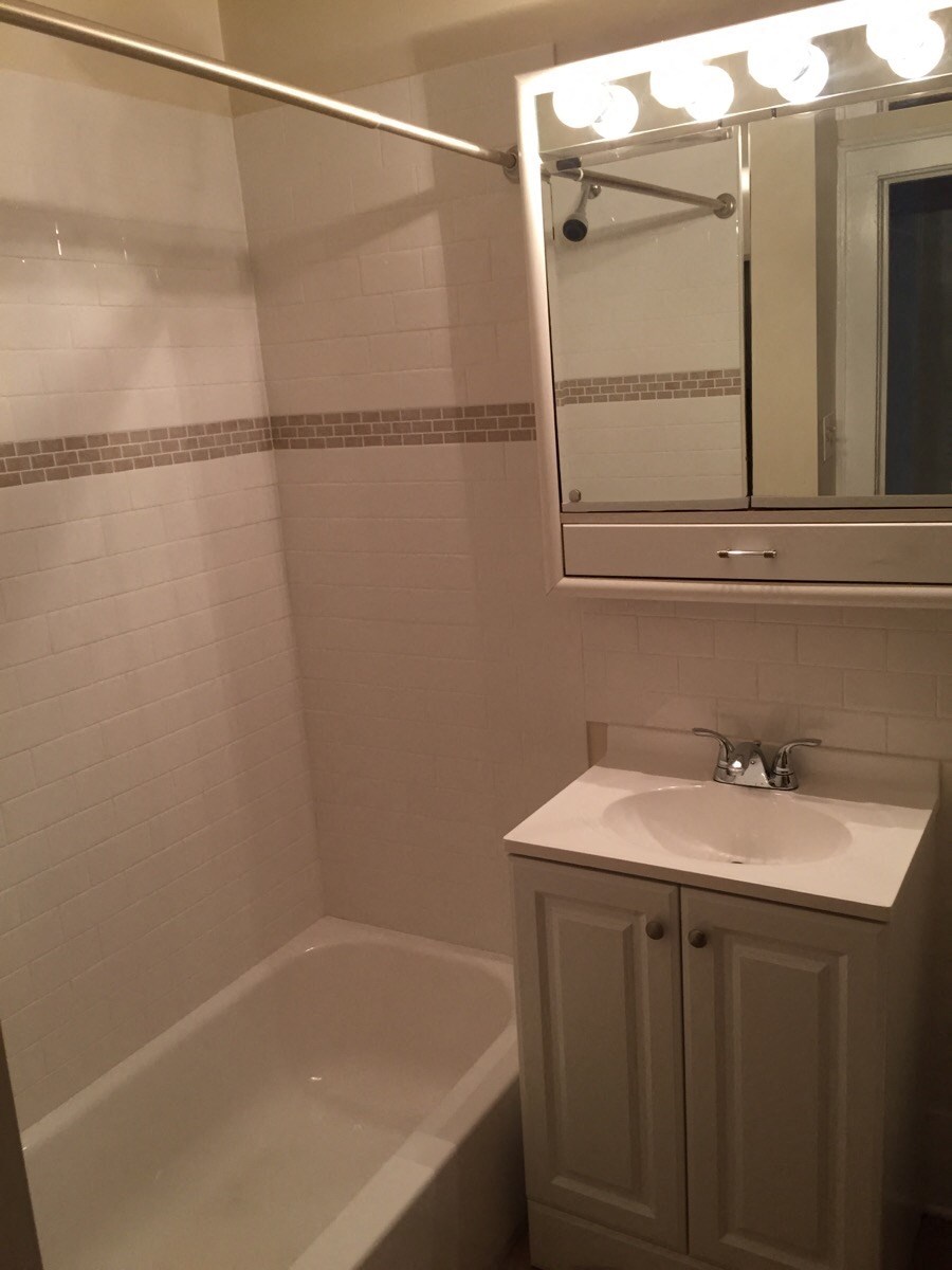 a small bathroom with a sink and a bath tub