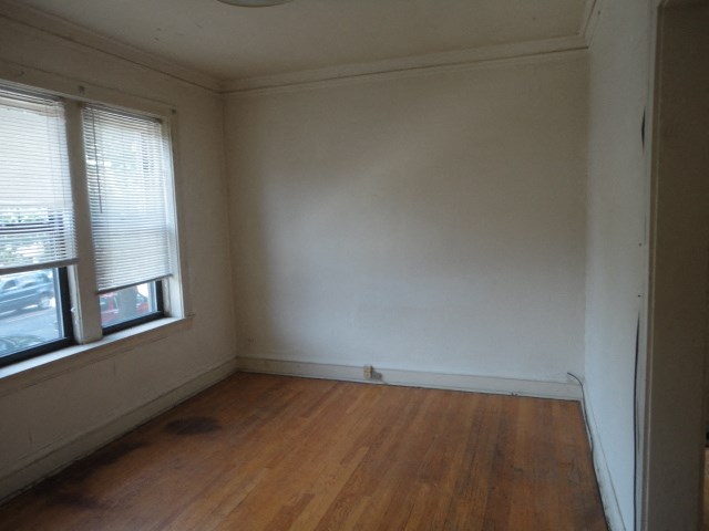 an empty room with white walls and a window