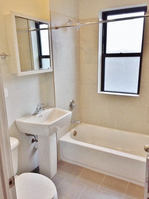 a bathroom with a sink toilet and a bath tub