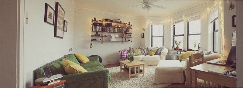 a living room filled with furniture and a ceiling fan
