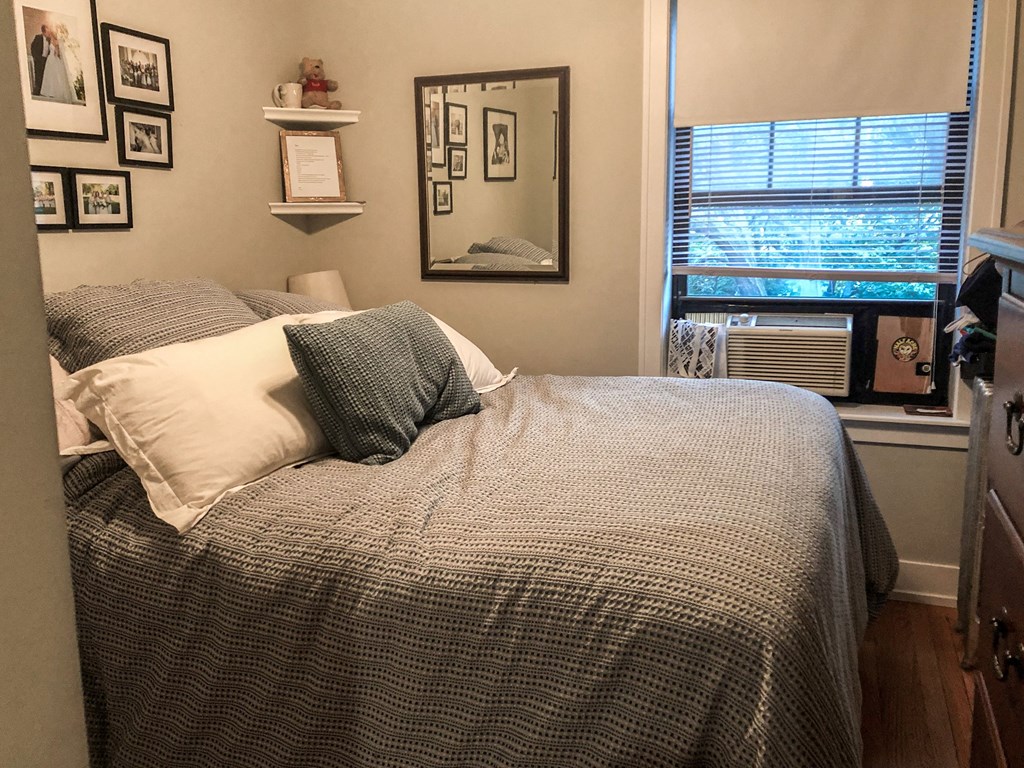 a bedroom with a bed and a window