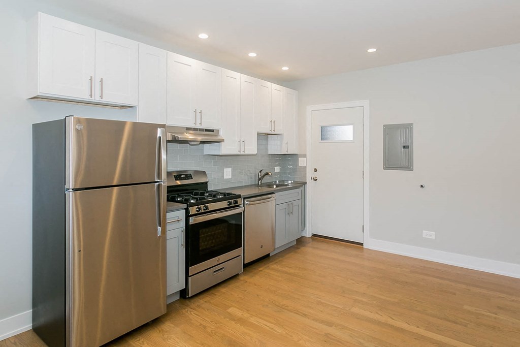 a kitchen with stainless steel appliances and white cabinets