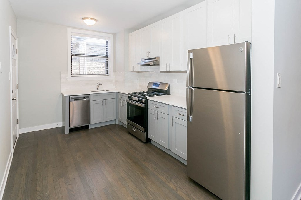 a kitchen with stainless steel appliances and white cabinets