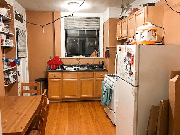 a kitchen with a refrigerator and a table