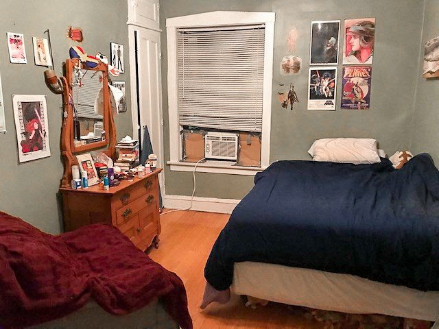 a bedroom with a bed and a dresser