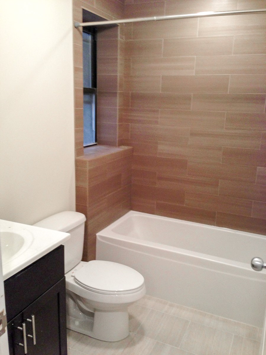 a small bathroom with a toilet and a bath tub