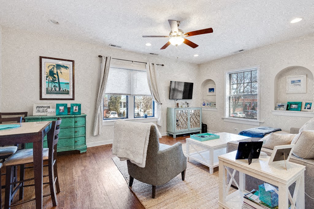 a living room with furniture and a ceiling fan