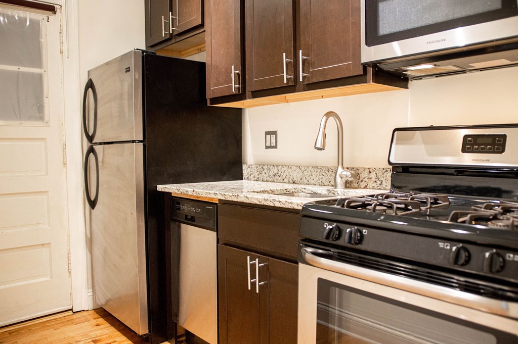 a kitchen with a stove and a refrigerator