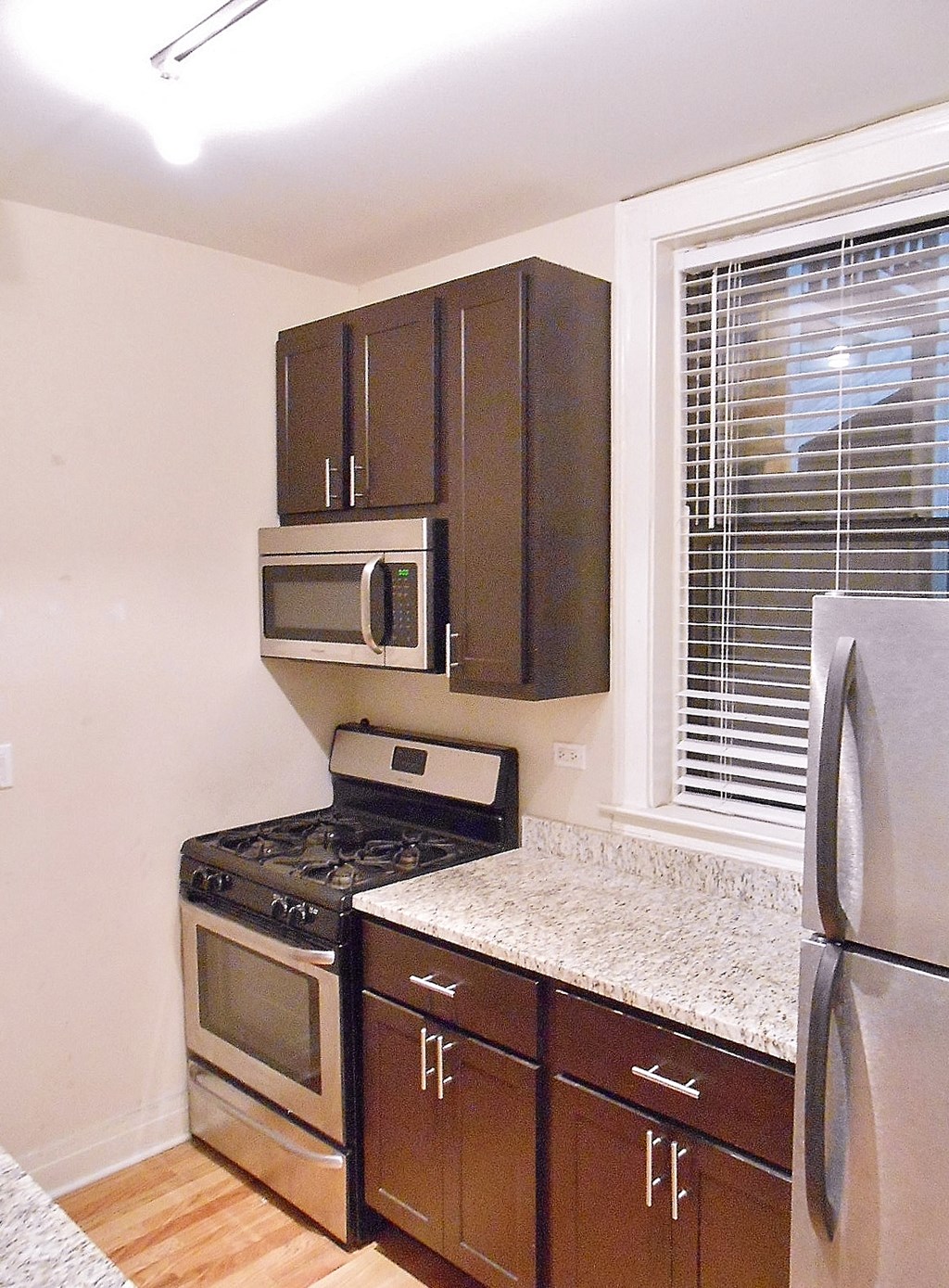 a kitchen with stainless steel appliances and wooden cabinets