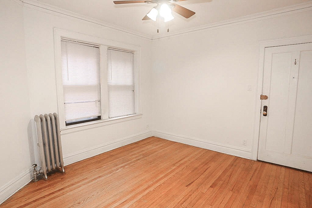 a room with a wood floor and a radiator