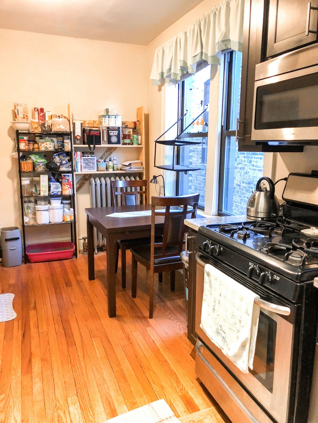 a kitchen with a stove and a table      and a refrigerator