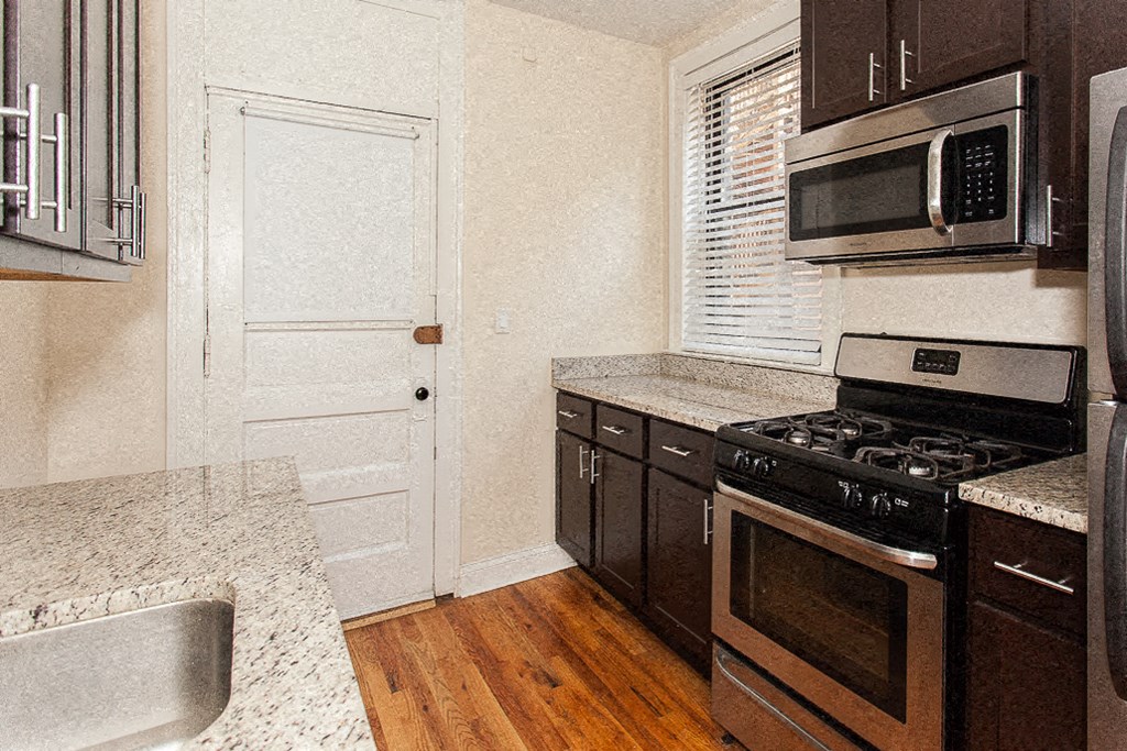 a kitchen with a stove microwave and a sink