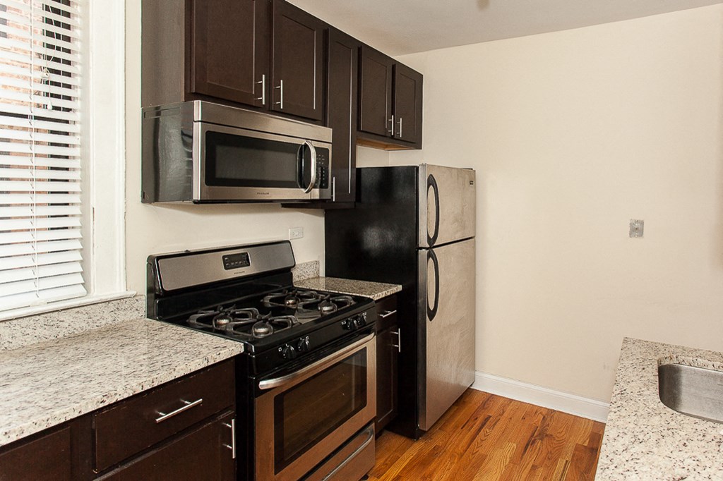 a kitchen with stainless steel appliances and granite counter tops