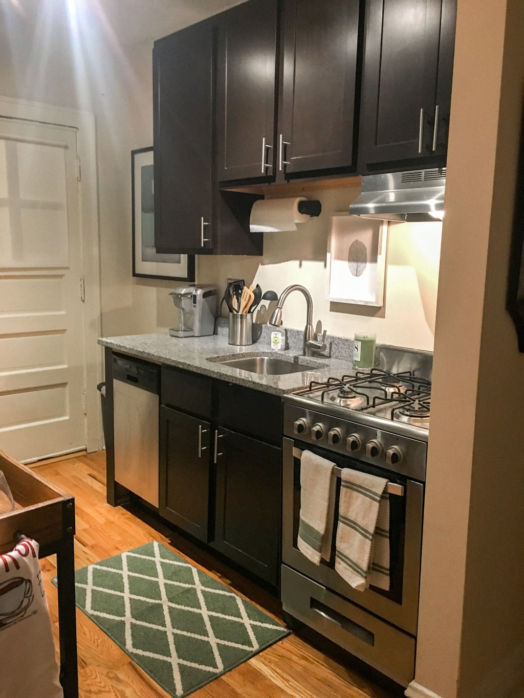 a kitchen with black cabinets and a stainless steel stove