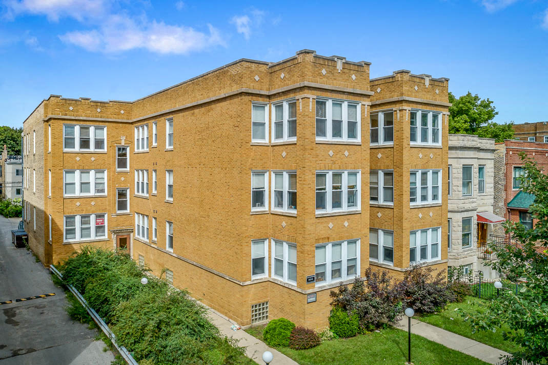 a large brick apartment building with many windows