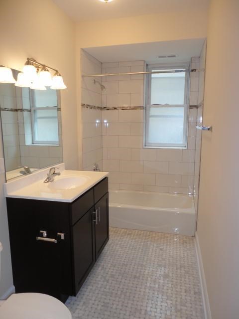 a small bathroom with a sink and a shower