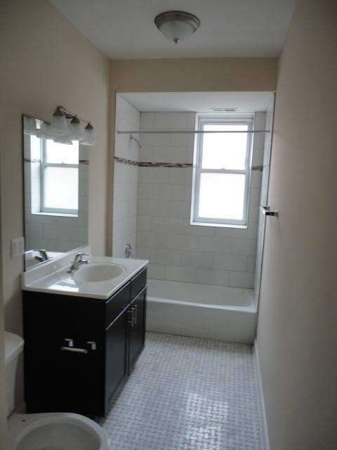 a bathroom with a sink and a shower and a toilet