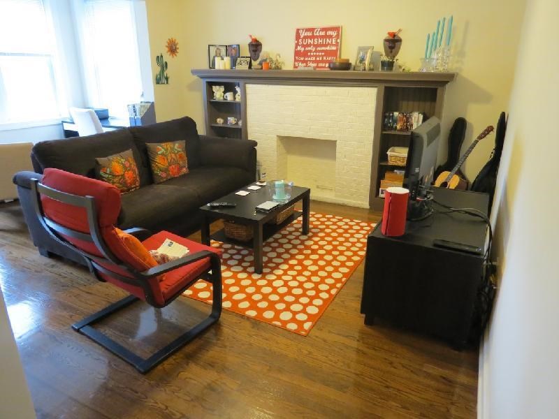 a living room with a couch and chair and a fireplace