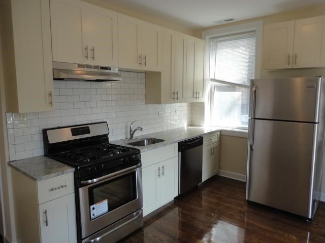 a kitchen with stainless steel appliances and white cabinets