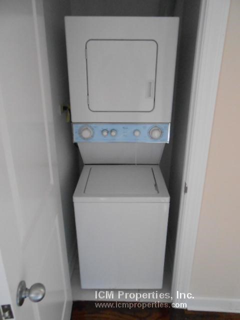 a white washer and dryer in a small closet