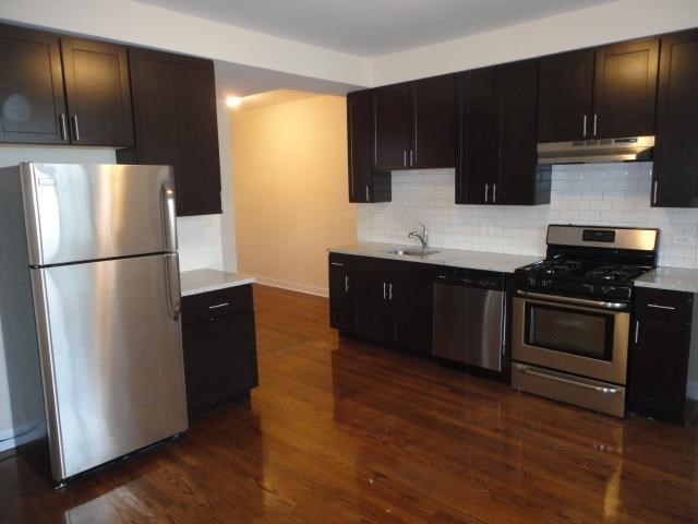 a kitchen with stainless steel appliances and black cabinets
